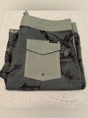Huk Performance Fishing Green Board Shorts with Mermaid/Marlin Graphics